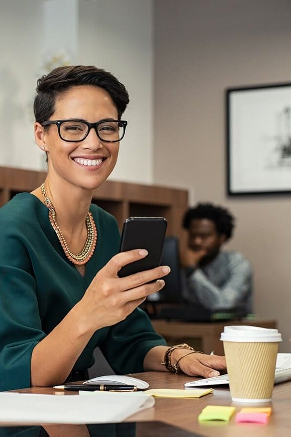 stylish-business-woman-using-smartphone-7ASWUC9.jpg